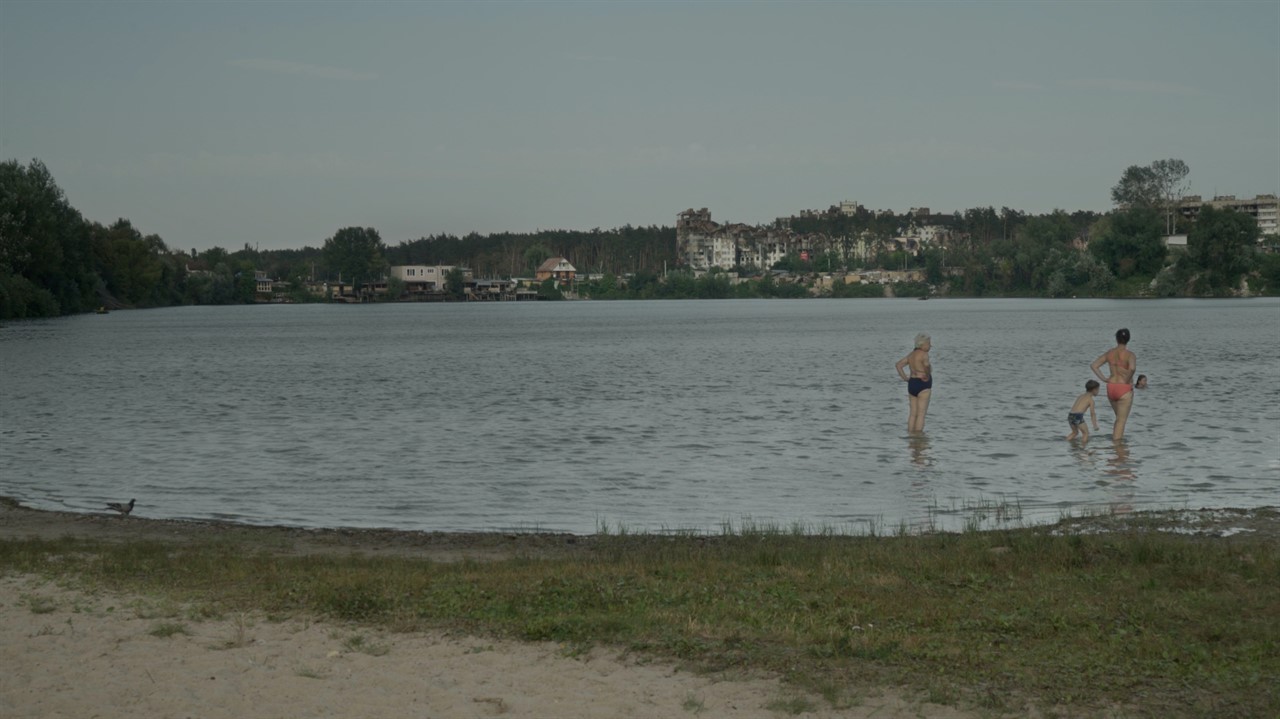Small lake with people standing in the water